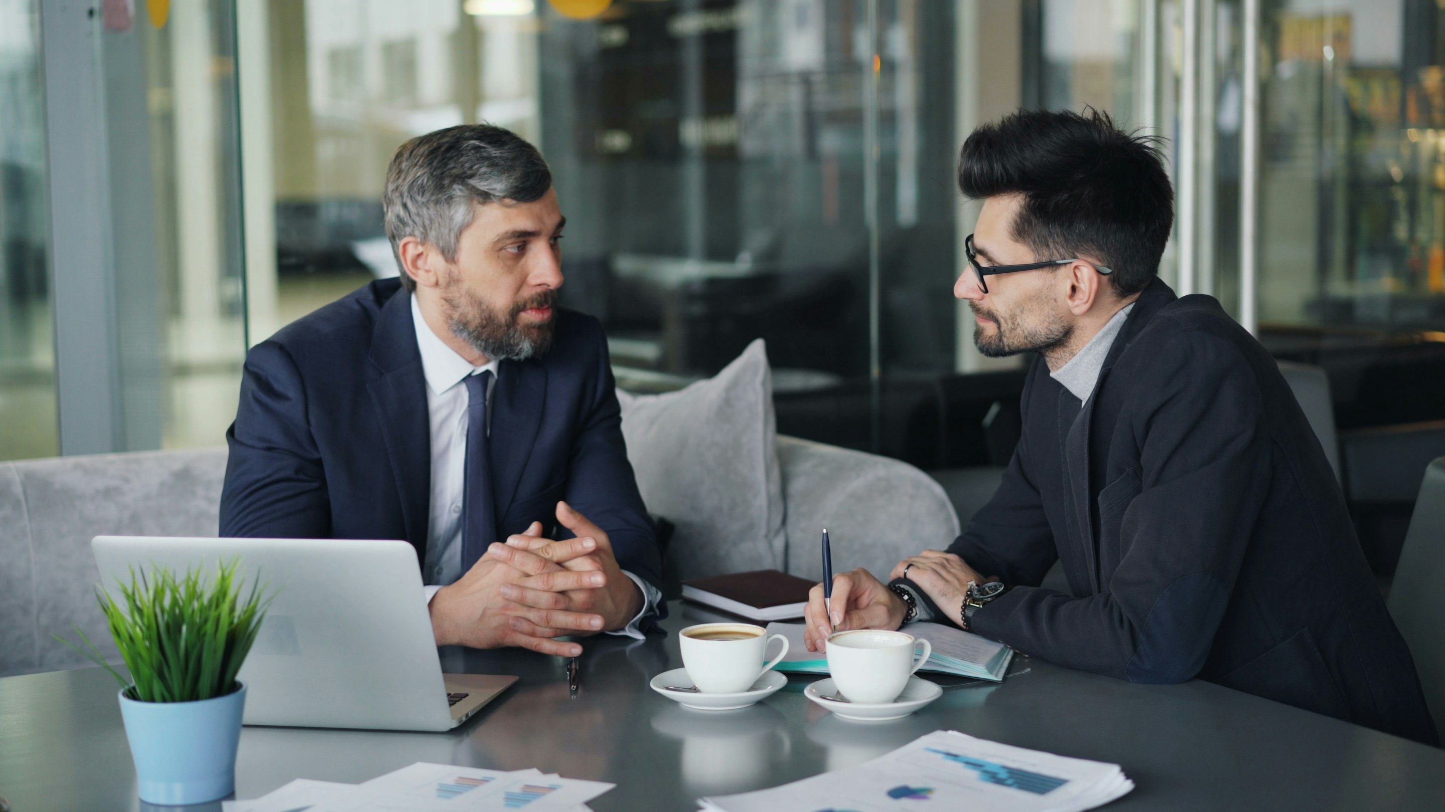 Colleagues talking through a project around a meeting table