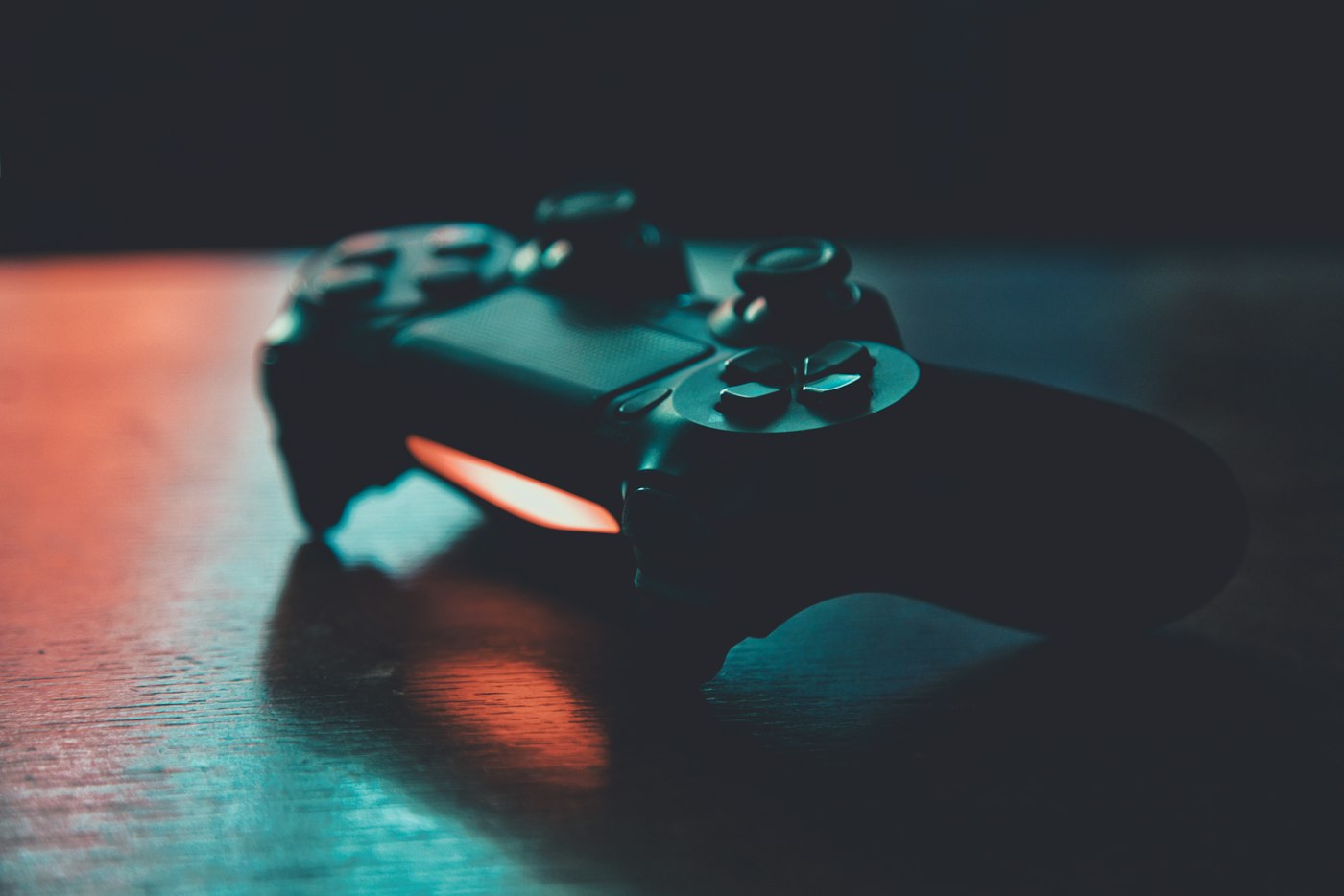 A gamepad under blue and orange lighting